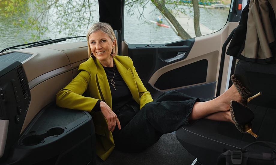 Women leaning back in the driver's cabin in a truck.