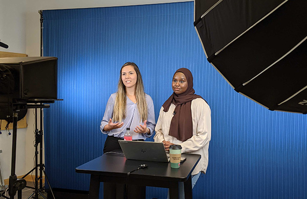 Two women recording a video in a studio