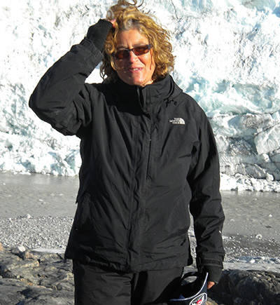 woman standing in front of a glacier