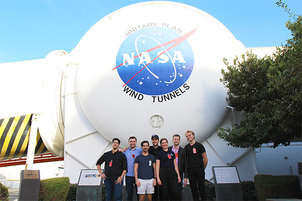 Group image in front of NASA logo