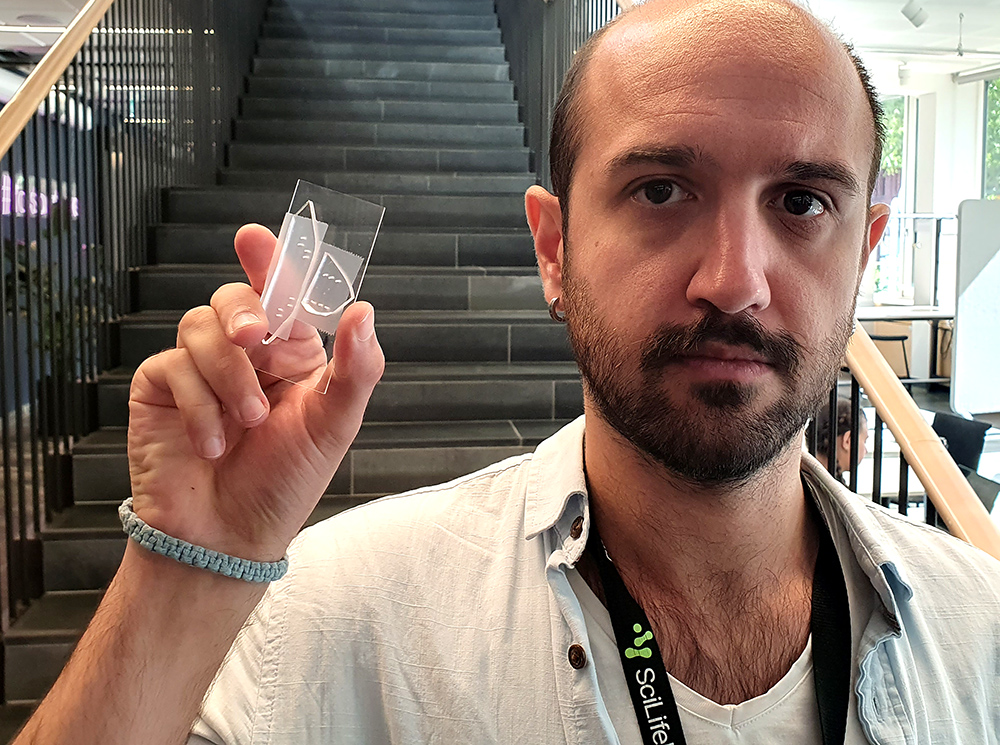 Man holding transparent microchip.