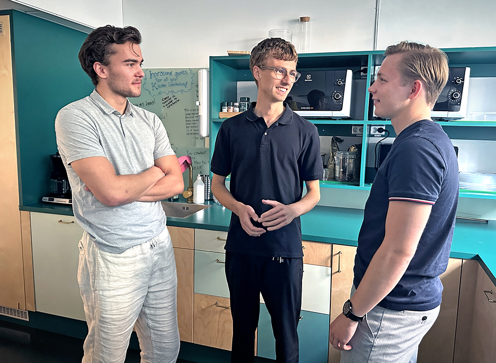 Three young men in a kitchen