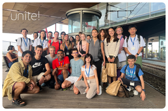 A large group of students in front of a train