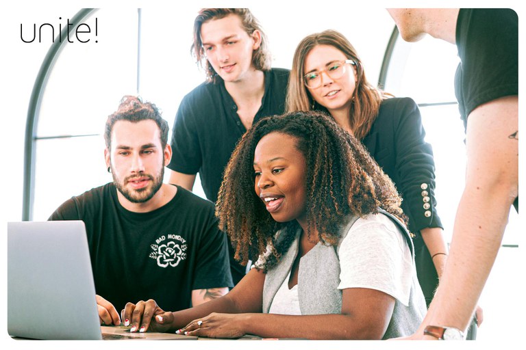 A group of people working on a laptop