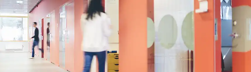 A student walks into an office