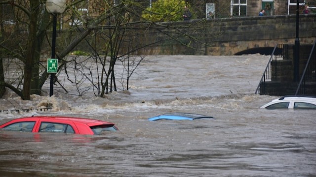 Cars almost wholly covered by a flood. 